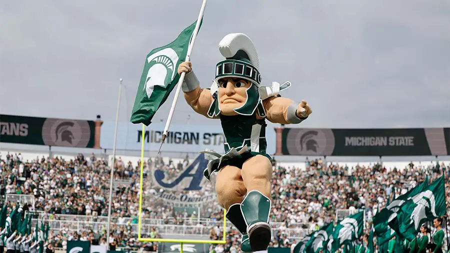 Sparte mascot holding a flag