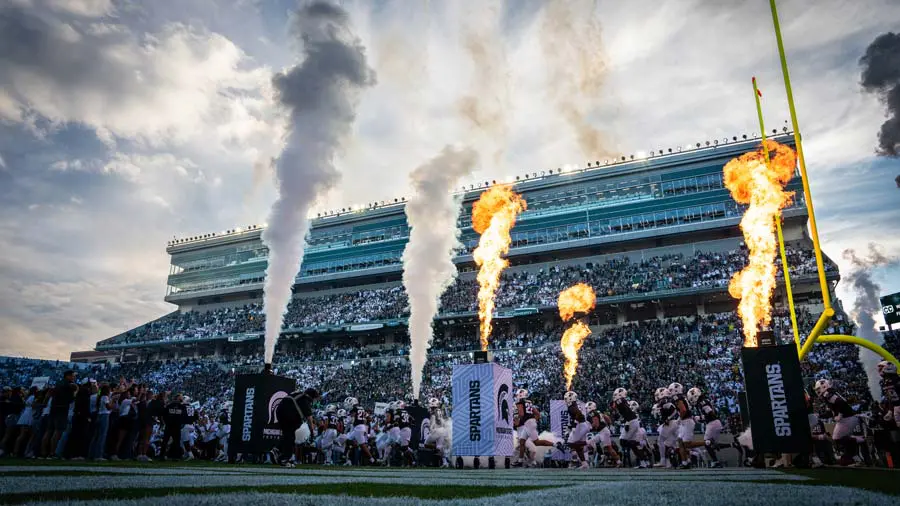 Part of stadium with pyrotechnics in foreground
